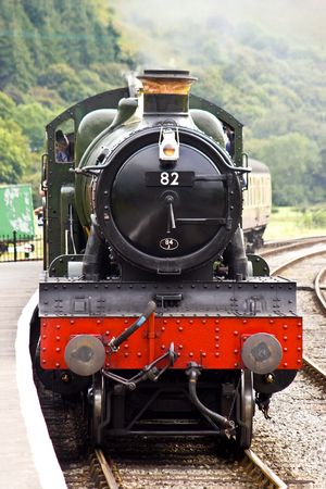 A steam train arrives in the station on a preserved Victorian railwayの写真素材