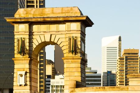 The memorial arch contrasts with the modern buildings behind. Southbank Brisbane, Queensland, Australiaの写真素材
