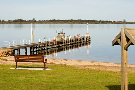 A Pier and boat on the beach in Metung, New South Wales, Australiaの写真素材