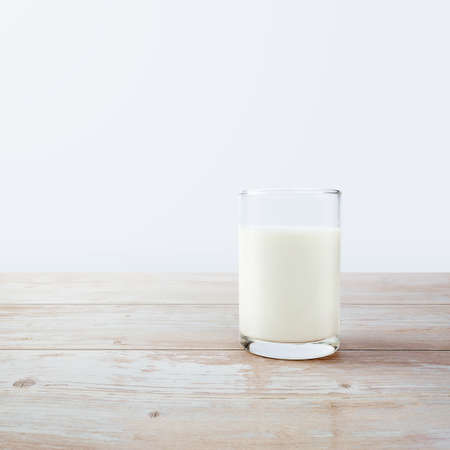 A glass of milk on the tableの写真素材