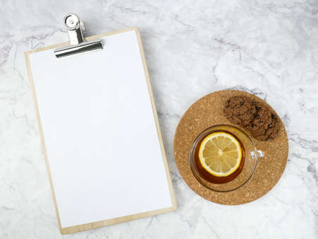 Lemon tea and pad paper on marble texture background.の写真素材