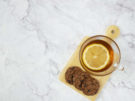Lemon tea and cookies on marble texture background.の写真素材
