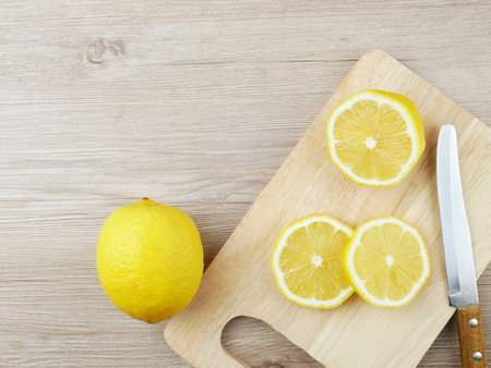 Sliced lemon lies on a wooden board.
