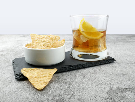 Cola drink with lemon and snack