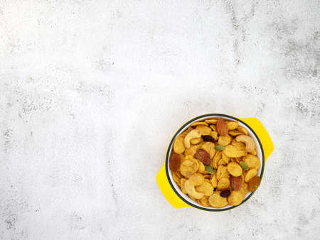 Grains cornflakes in bowl on white texture background.の写真素材