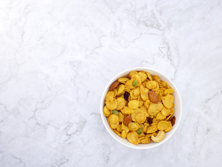 Grains cornflakes in bowl on marble background.の写真素材
