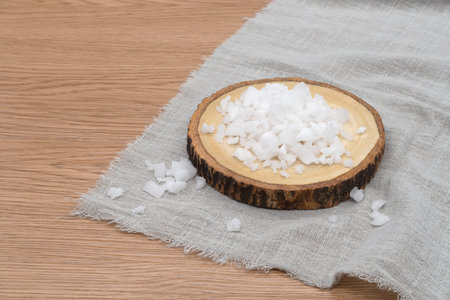 Sea salt on a wooden tray with cloth on wooden texture background