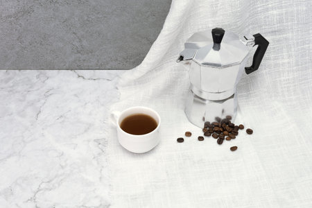 Coffee cup with a moka pot on cloth texture background.の写真素材