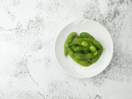 Edamame beans in dish on stone texture background. green soybeans seeds.の写真素材
