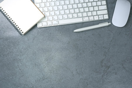 Top view above of office desk table with keyboard computer. Business and finance concept. Workplace. Flat lay with blank copy space. Stone texture.の写真素材