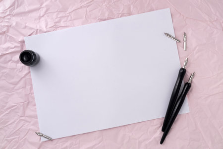 Blank paper with dip pen on wrinkled paper texture background. Writer workplace concept.