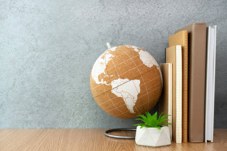 Notebook and globe on table. Work desk spaceの写真素材