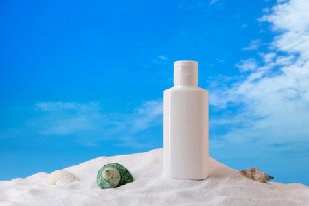Cream tube and shells on the sand. Cosmetic product for mock up