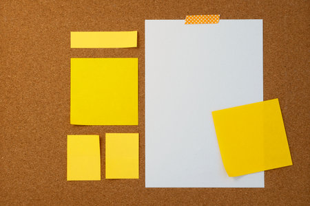 Blank sticky note paper on cork board wall. Noticeboard to organize life and work conceptの写真素材