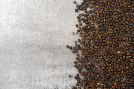 Black pepper pile on stone texture background