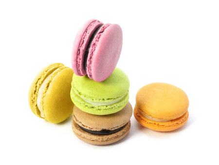 Pile of macaron cookies in various flavours and colours isolated on white background.の写真素材