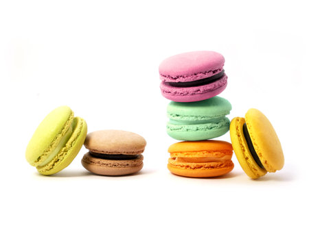 Pile of macaron cookies in various flavours and colours isolated on white background.の写真素材