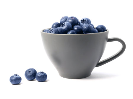 Blueberries in cup isolated on white backgroundの写真素材