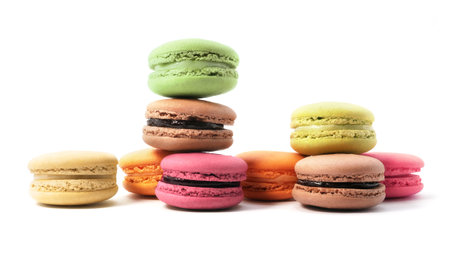 Pile of macaron cookies in various flavours and colours isolated on white background.の写真素材