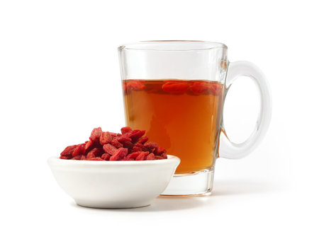 Cup of tea with goji berries isolated on white backgroundの写真素材
