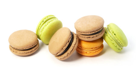 Pile of macaron cookies in various flavours and colours isolated on white background.の写真素材