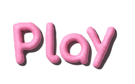 Pink clay letters spell 'Play' isolated  on white background. clay texture. 3d renderingの写真素材