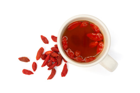 Cup of tea with goji berries isolated on white backgroundの写真素材