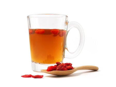 Cup of tea with goji berries isolated on white backgroundの写真素材