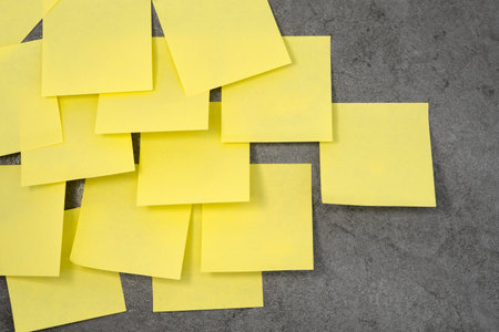 Multiple sheets sticky notes on the wallの写真素材