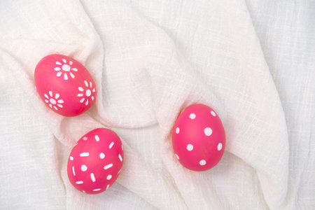 Pink easter eggs on fabric texture background. Painted eggs. Egg Holidayの写真素材