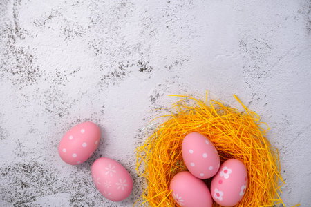Colorful easter eggs in bird's nest on stone texture background. Painted eggs. Egg Holiday