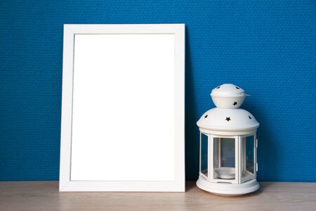 White frame and lamp with blue wallpaperの写真素材