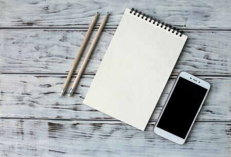 Mobile note and pencil on the boardの写真素材