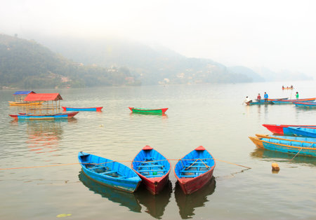 View of Phewa lake with colourful boats together in Pokhara,Nepal.の写真素材