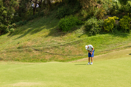 Kathmandu,Nepal - March 23,2016: An unidentified Golfer ready to shot a ball at the Royal Nepal Golf Course,Kathmandu on a Sunny day.のeditorial素材
