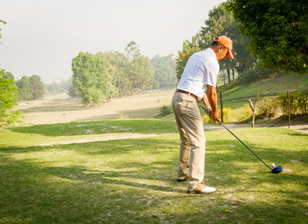 Kathmandu,Nepal - March 23,2016: An unidentified Golfer ready to shot a ball at the Royal Nepal Golf Course,Kathmandu on a Sunny day.のeditorial素材