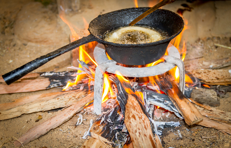 Cooking Rice bread  on firewood traditionally in the rural village of Nepal.の写真素材