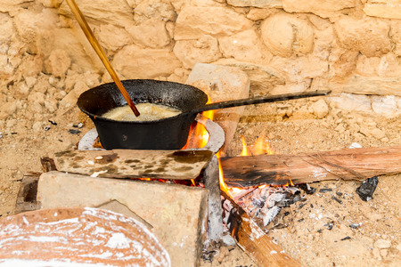 Cooking Rice bread  on firewood traditionally in the rural village of Nepal.の写真素材