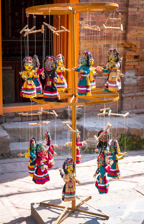 Puppets or Doll kept for sale hanging in the wooden hanger.の写真素材