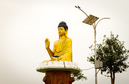 Golden Statue of Budhda with his blessing hand.の写真素材