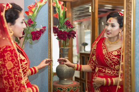 Beautiful Nepali Bride with wedding dress and make up at the wedding ceremony in Nepal.のeditorial素材