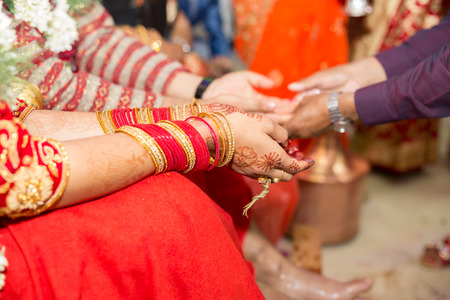 Hindu Nepali Bride and groom's Hands on the wedding day.の写真素材