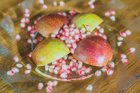 Fresh Apple Slices and pomegranate Seeds on a plate.の写真素材
