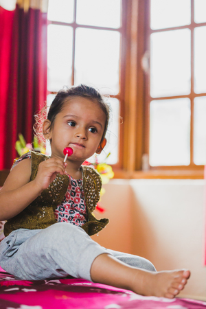Happy Asian baby boy having fun with eating lollipop.Children having lollipopの写真素材