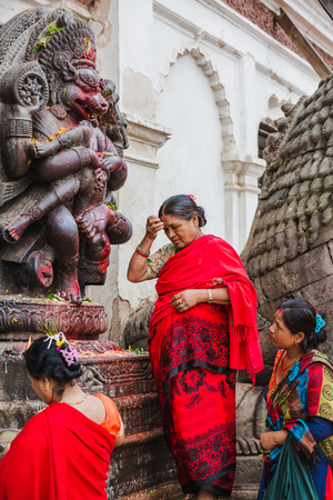 Bhaktapur,Nepal - August 4,2018 : Nepali Women worshiping Hindu goddess at the Temple in Bhaktapur Nepal.のeditorial素材