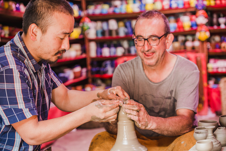 Bhaktapur,Nepal - August 4,2018 :Foreigner / Tourist Making a Ceramic Pot at Pottery Square in Bhaktapur.It is an ancient newar town near kathmandu.のeditorial素材