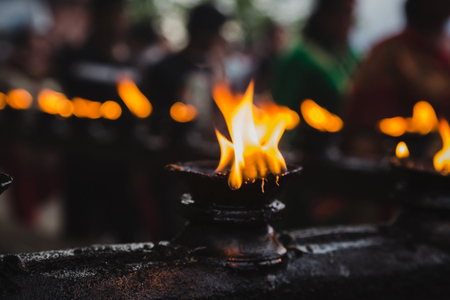 Oil lamps burning together in a row  in the temple of kathmandu Nepal.の写真素材