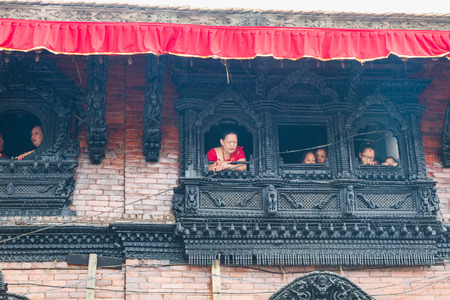 Kathmandu,Nepal - Sep 5,2017: Nepali people watching outside from artistic wooden windows in kathmandu.のeditorial素材