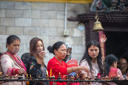 Kathmandu,Nepal - Sep 08,2018: Hindu women offering prayers to god according to hindu rituals in the...