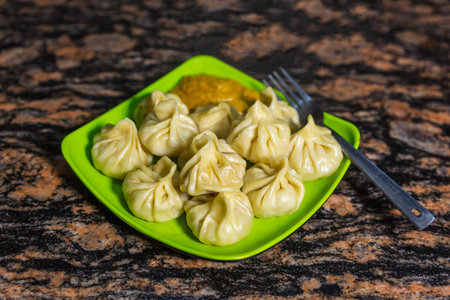 Home made traditional dumpling momos food of Nepal served on a plate with special Momo Sauce....